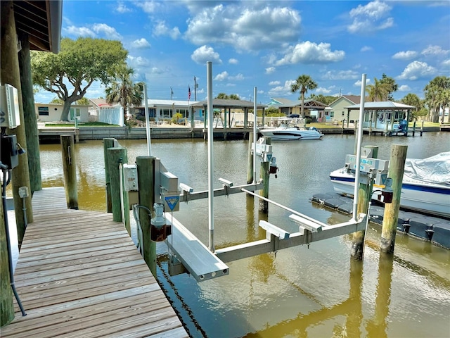 807 N Flagler Ave, Flagler Beach, FL 32136 - dock featuring boat lift, a water view, and a residential view