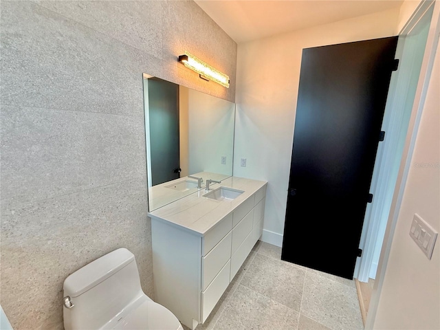 807 N Flagler Ave, Flagler Beach, FL 32136 - bathroom with toilet, vanity, tile patterned flooring, and baseboards