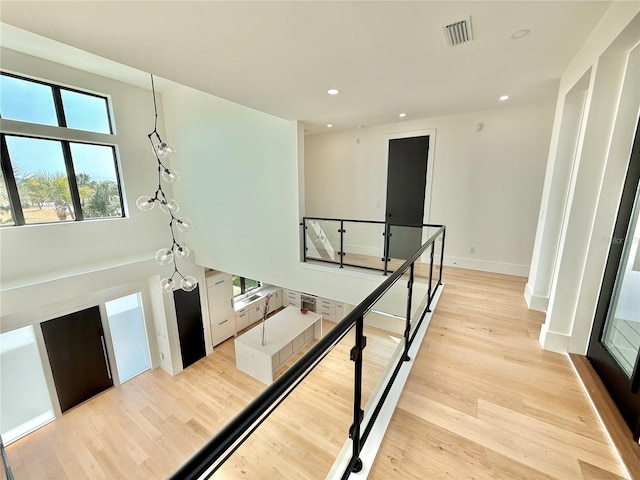 807 N Flagler Ave, Flagler Beach, FL 32136 - hall featuring an upstairs landing, recessed lighting, light wood-type flooring, and baseboards