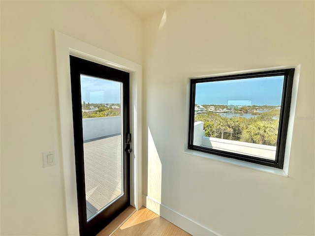 807 N Flagler Ave, Flagler Beach, FL 32136 - doorway to outside featuring wood finished floors and baseboards
