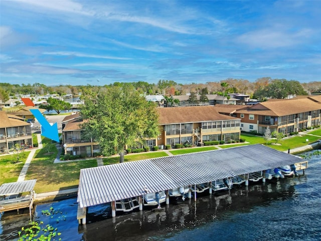 dock area with a residential view, a water view, and a yard