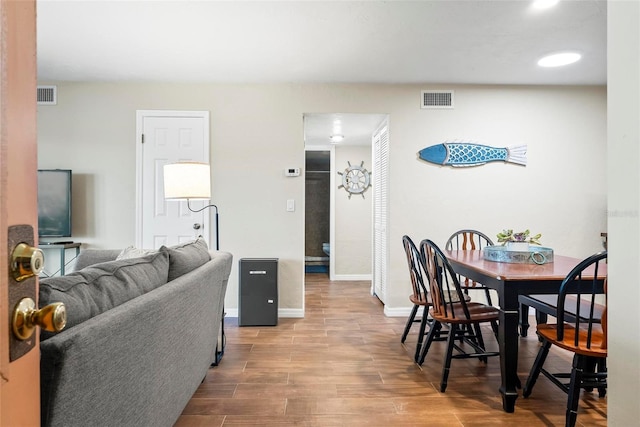 dining room featuring wood finished floors and baseboards