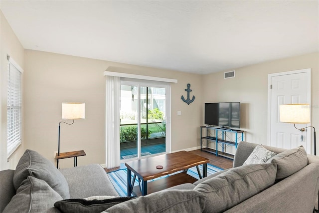 living room featuring wood finished floors and baseboards