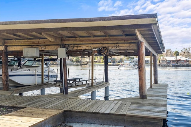 dock featuring boat lift and a water view