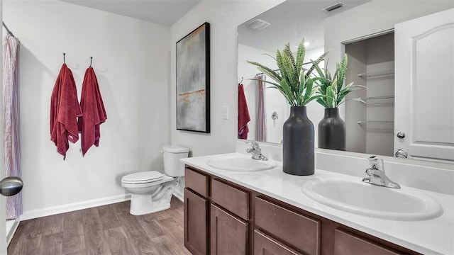 804 Grand Reserve Dr, Bunnell, FL 32110 - full bath with toilet, baseboards, wood finished floors, and double vanity