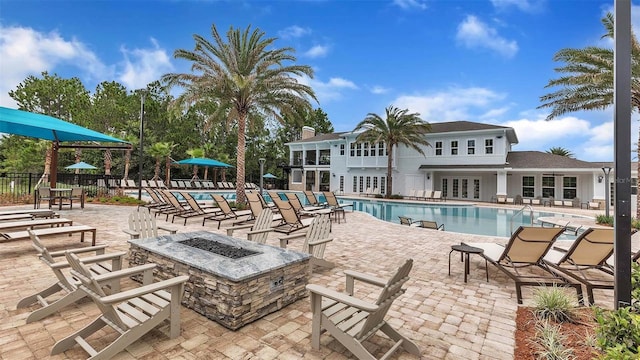 804 Grand Reserve Dr, Bunnell, FL 32110 - community pool with french doors, an outdoor fire pit, fence, and a patio area