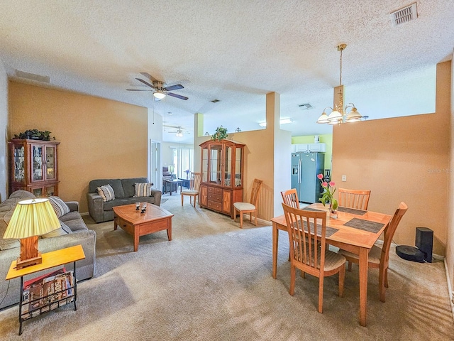 7 Bunker View Dr, Palm Coast, FL 32137 - dining space featuring ceiling fan, carpet, a chandelier, a textured ceiling, and lofted ceiling
