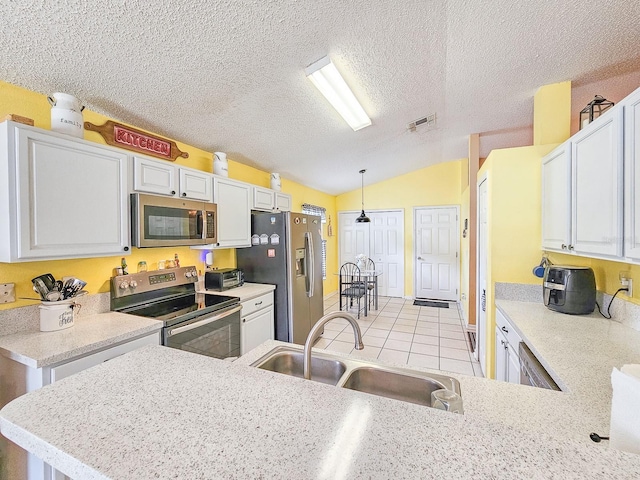 7 Bunker View Dr, Palm Coast, FL 32137 - kitchen featuring stainless steel appliances, a sink, vaulted ceiling, pendant lighting, and light tile patterned flooring