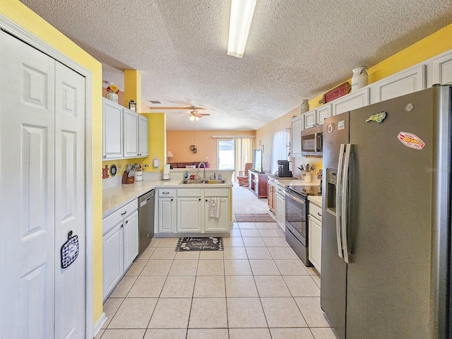 7 Bunker View Dr, Palm Coast, FL 32137 - kitchen with appliances with stainless steel finishes, a peninsula, a sink, light countertops, and ceiling fan