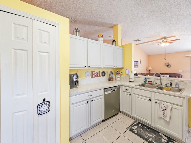 7 Bunker View Dr, Palm Coast, FL 32137 - kitchen with stainless steel dishwasher, a sink, light tile patterned floors, a textured ceiling, and light countertops