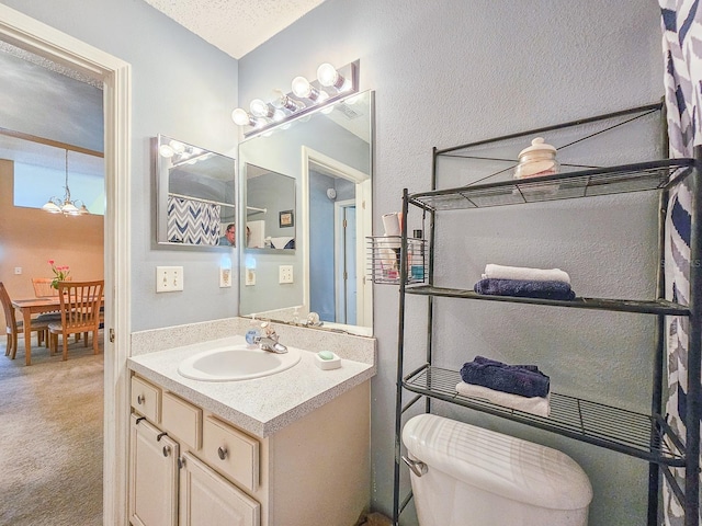 7 Bunker View Dr, Palm Coast, FL 32137 - bathroom with vanity, toilet, and a chandelier