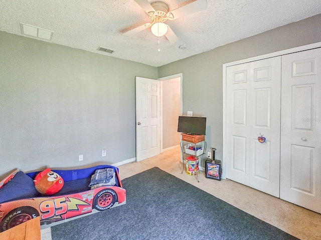 7 Bunker View Dr, Palm Coast, FL 32137 - bedroom with a textured ceiling, carpet, ceiling fan, and a closet