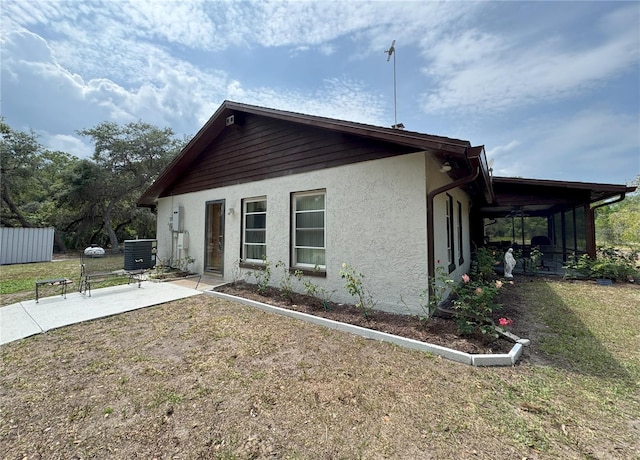 486 S US Highway 1, Oak Hill, FL 32759 - view of front facade with stucco siding, central AC, a patio area, and a front yard
