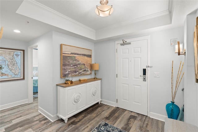 entrance foyer with ornamental molding, wood finished floors, baseboards, and recessed lighting
