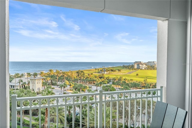 balcony with a water view and golf course view