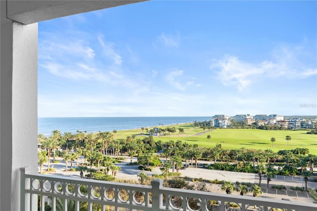 balcony with a water view and golf course view