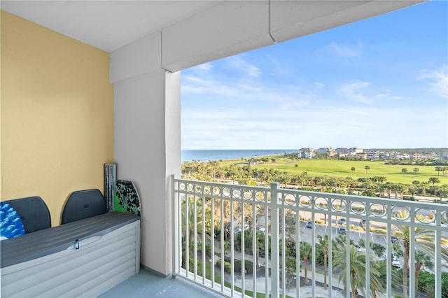 balcony with a water view and golf course view