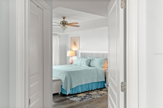 bedroom with dark wood-type flooring and a ceiling fan
