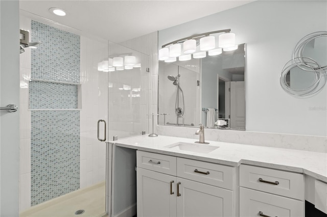 full bathroom featuring a shower stall and vanity