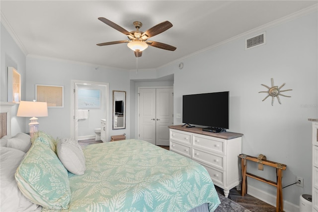 bedroom with baseboards, ornamental molding, a closet, ensuite bathroom, and a ceiling fan