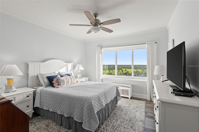 bedroom with dark wood finished floors, ornamental molding, baseboards, and ceiling fan