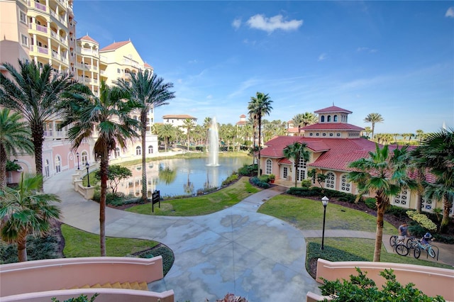 view of property's community featuring a water view and a lawn