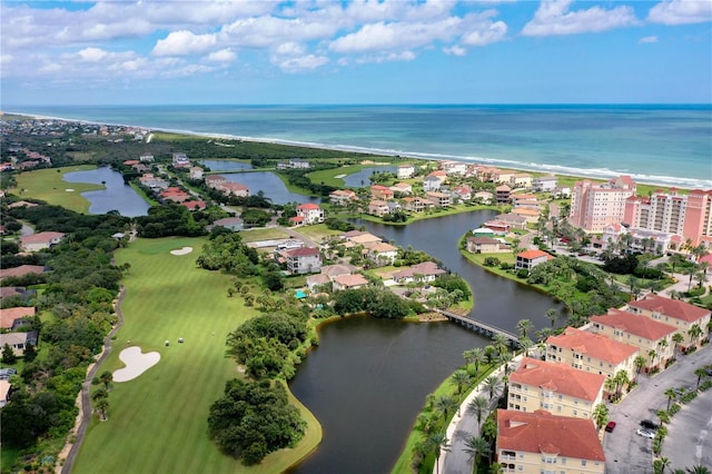 aerial overview of property's location with a large body of water, a golf course, and apartment complex