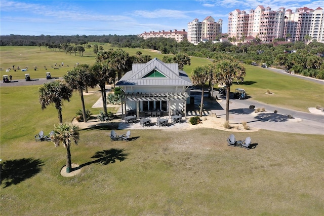 drone / aerial view of apartment complex / building and a golf course
