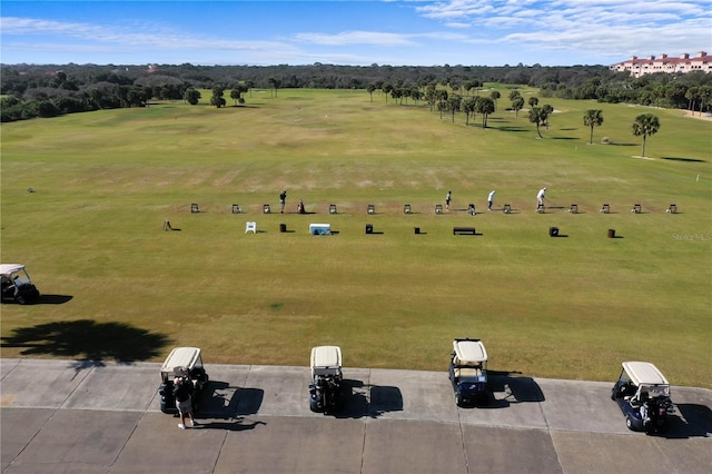 bird's eye view of a local golf course and a tree filled landscape