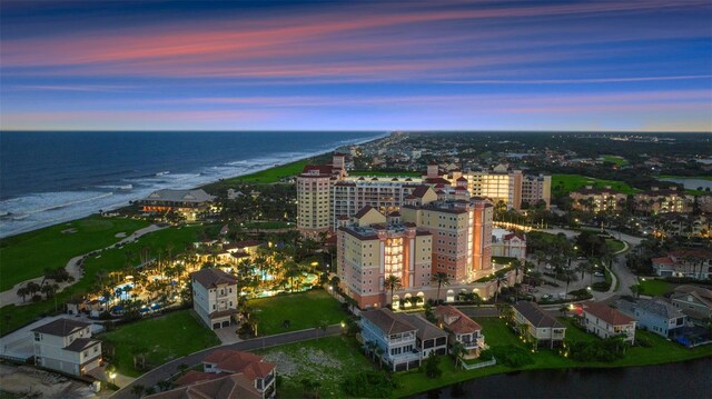 aerial view of property and surrounding area with unending shoreline and nearby urban area