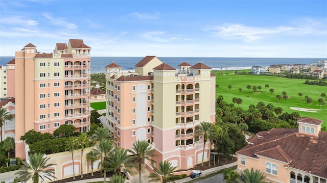 view of apartment building / complex with view of golf course and a water view
