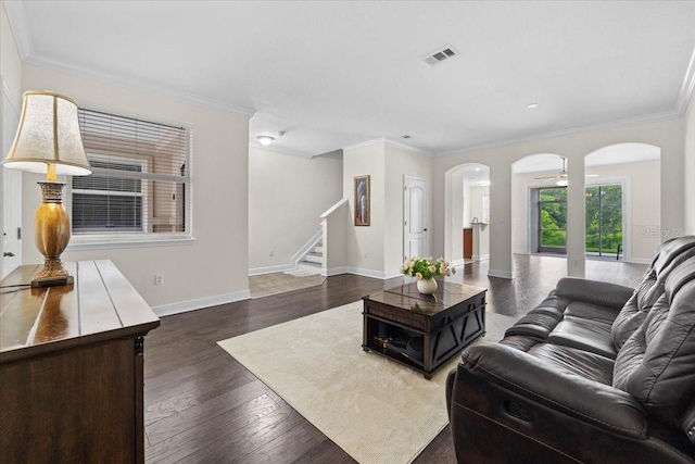 70 Riverview Bnd S Unit 715, Palm Coast, FL 32137 - living room with arched walkways, stairway, ornamental molding, baseboards, and dark wood-style flooring