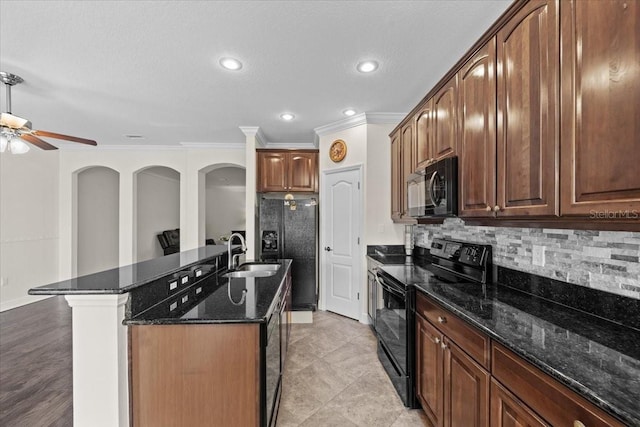70 Riverview Bnd S Unit 715, Palm Coast, FL 32137 - kitchen with black appliances, a sink, crown molding, decorative backsplash, and a center island with sink