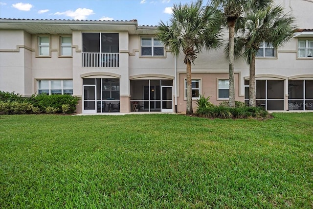 70 Riverview Bnd S Unit 715, Palm Coast, FL 32137 - back of property featuring stucco siding and a lawn