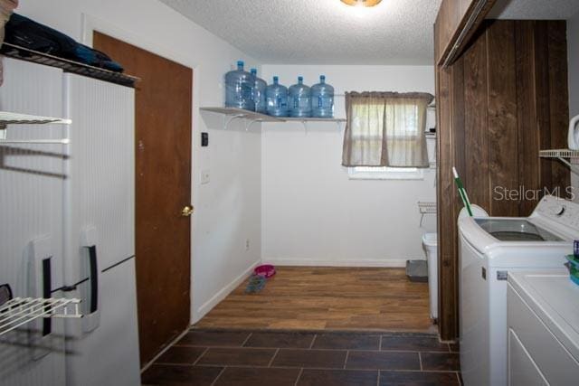 laundry area featuring washing machine and dryer and a textured ceiling