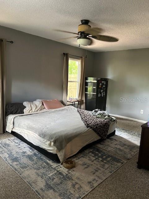 1 Belvedere Ln, Palm Coast, FL 32137 - bedroom featuring carpet, a textured ceiling, and ceiling fan
