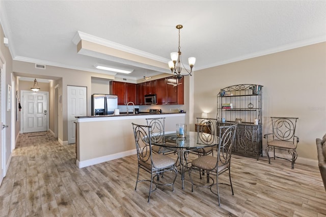 dining space featuring crown molding, light wood finished floors, a chandelier, and baseboards
