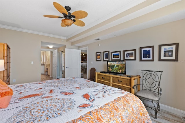 bedroom featuring ornamental molding, baseboards, light wood finished floors, connected bathroom, and a closet