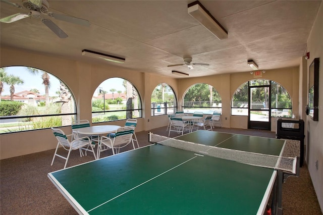 recreation room with ceiling fan and carpet flooring