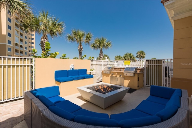 view of patio / terrace with an outdoor living space with a fire pit, an outdoor kitchen, a grill, and fence
