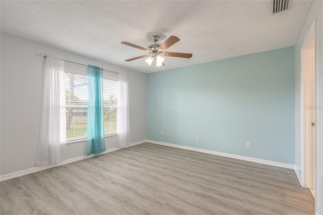 613 Clairmont Ln, South Daytona, FL 32119 - unfurnished room featuring healthy amount of natural light, light wood-style flooring, a textured ceiling, ceiling fan, and baseboards