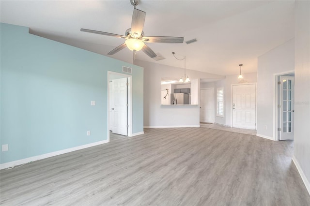 613 Clairmont Ln, South Daytona, FL 32119 - unfurnished living room with a ceiling fan, wood finished floors, baseboards, and vaulted ceiling