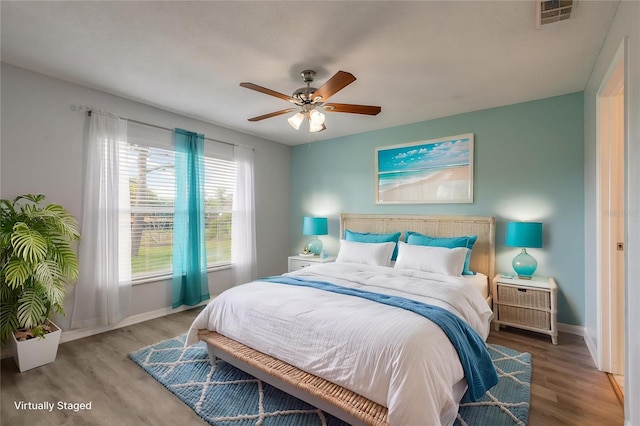 613 Clairmont Ln, South Daytona, FL 32119 - bedroom featuring wood finished floors, baseboards, and ceiling fan