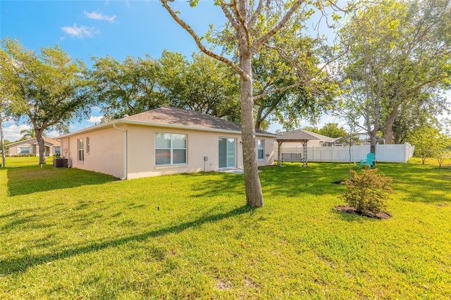 613 Clairmont Ln, South Daytona, FL 32119 - rear view of house with stucco siding and cooling unit