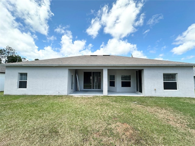 15 Ruth Dr, Palm Coast, FL 32164 - back of house featuring a patio area, a lawn, stucco siding, and roof with shingles