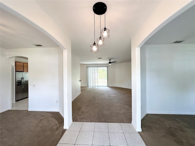 15 Ruth Dr, Palm Coast, FL 32164 - hallway featuring arched walkways, light colored carpet, and baseboards