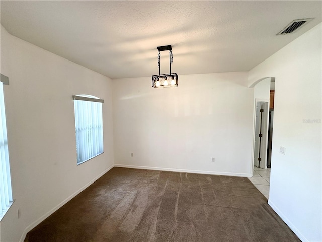 15 Ruth Dr, Palm Coast, FL 32164 - unfurnished room featuring arched walkways, carpet floors, and baseboards
