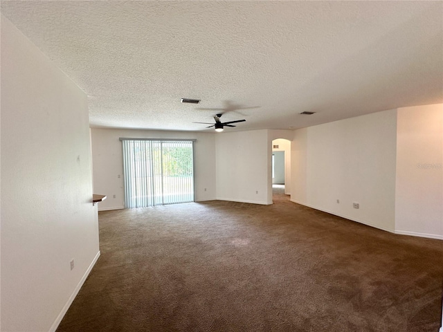 15 Ruth Dr, Palm Coast, FL 32164 - carpeted empty room with arched walkways, a ceiling fan, a textured ceiling, and baseboards