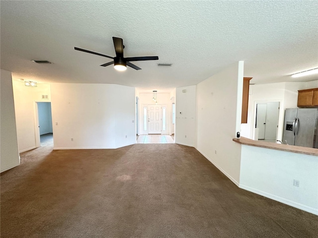 15 Ruth Dr, Palm Coast, FL 32164 - unfurnished living room with a ceiling fan, carpet flooring, baseboards, and a textured ceiling
