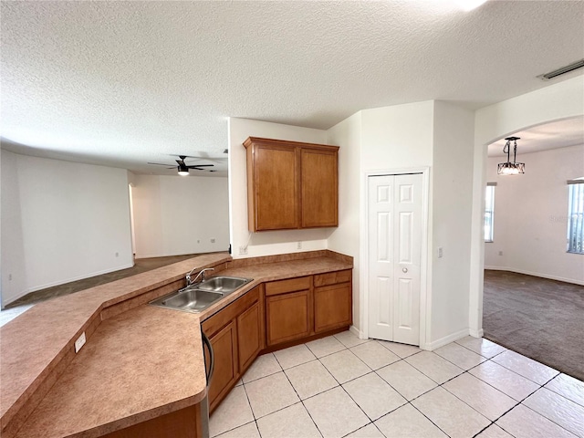 15 Ruth Dr, Palm Coast, FL 32164 - kitchen featuring a sink, open floor plan, brown cabinets, and a textured ceiling